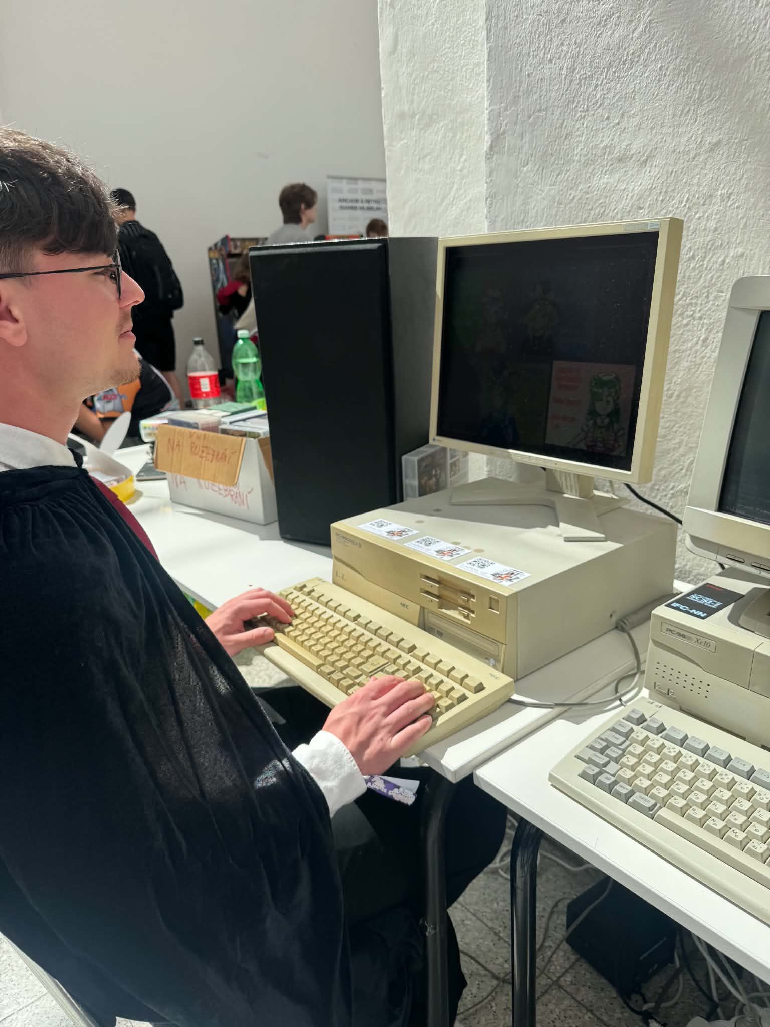 Adam Juhás using a vintage desktop computer